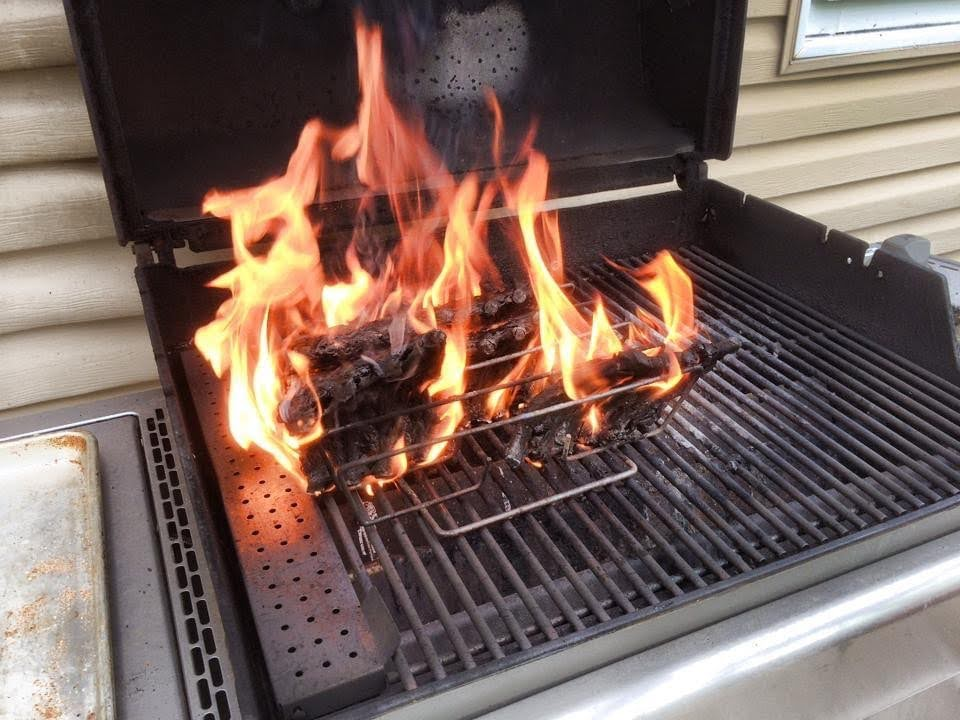 burning rack of lamb on a grill