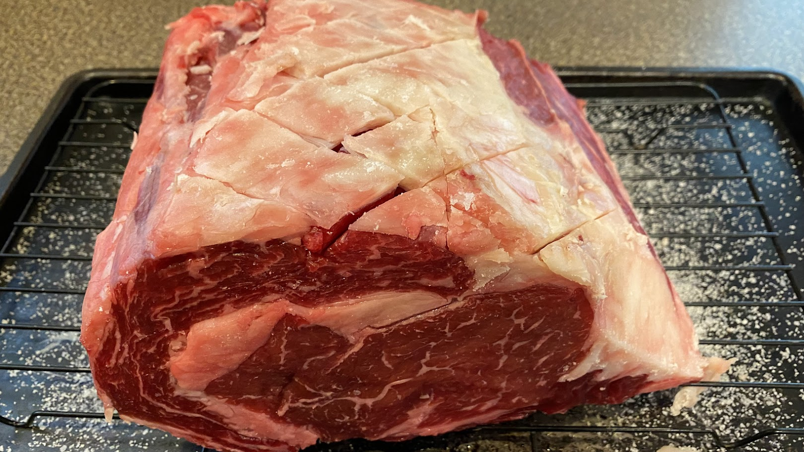 rare prime rib on a cookie sheet with a grate for Grillers Gold Blog