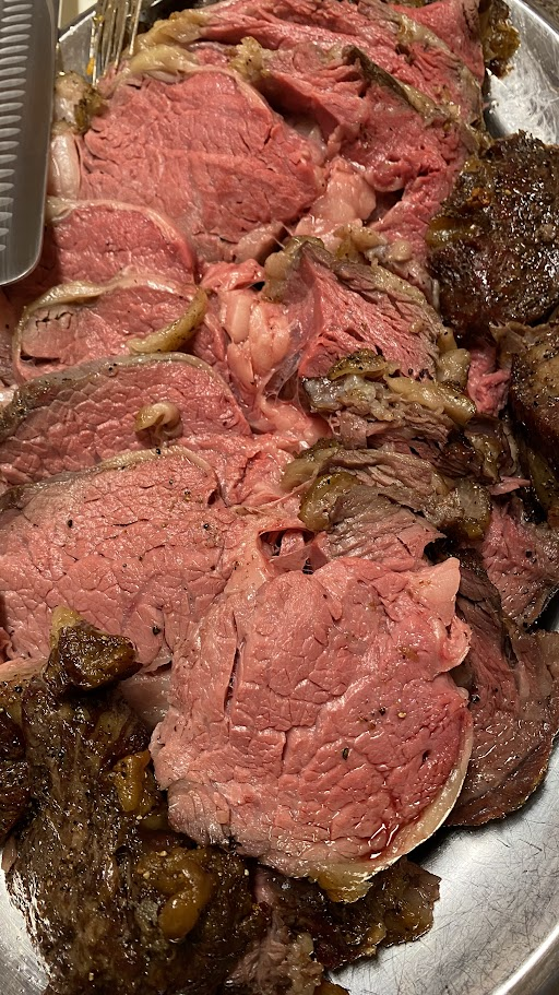 Freshly carved prime rib on a silver platter 