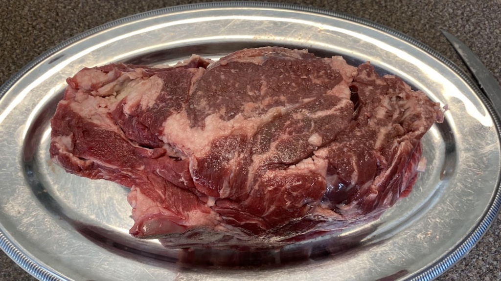 ribeye steak on a silver plate - Grillers Gold blog
