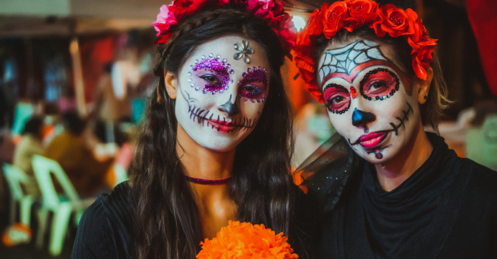 Day of the Dead women with vibrant face paint.